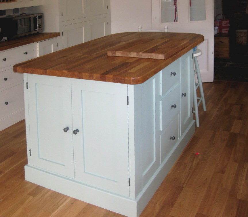 a blue painted kitchen island with breakfast bar and stools