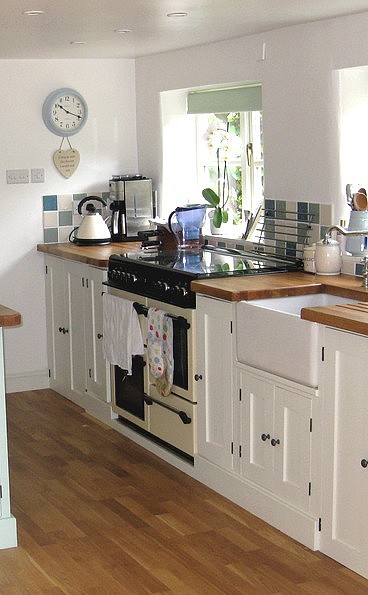 painted kitchen units with a range cooker