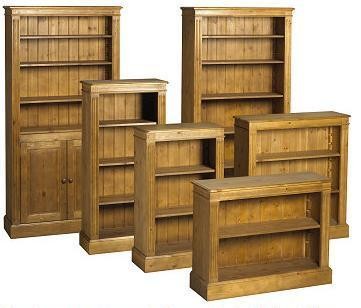 a group of pine bookcases of various sizes