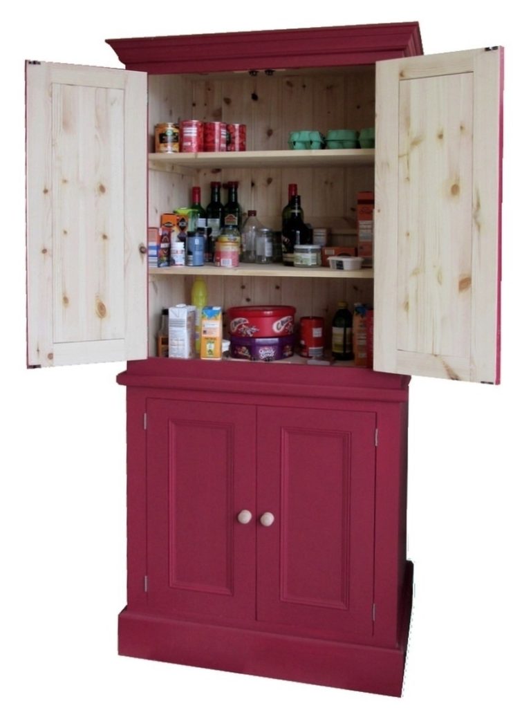 a red painted pine kitchen larder unit with the doors open and spice racks